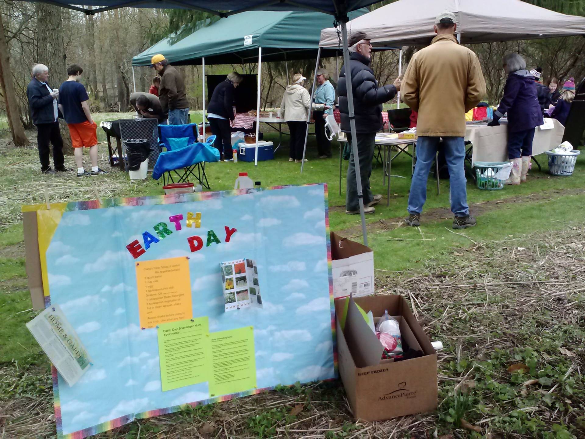 Outdoor birthday party setup with a colorful sign and gift box.