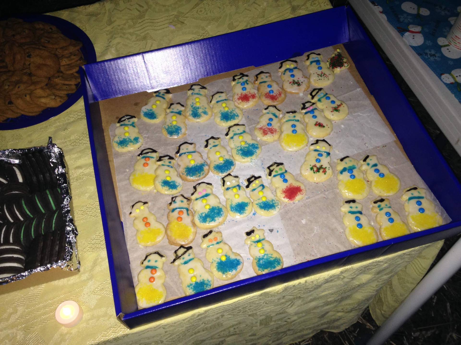 Tray of small, colorful decorated cookies on a table.