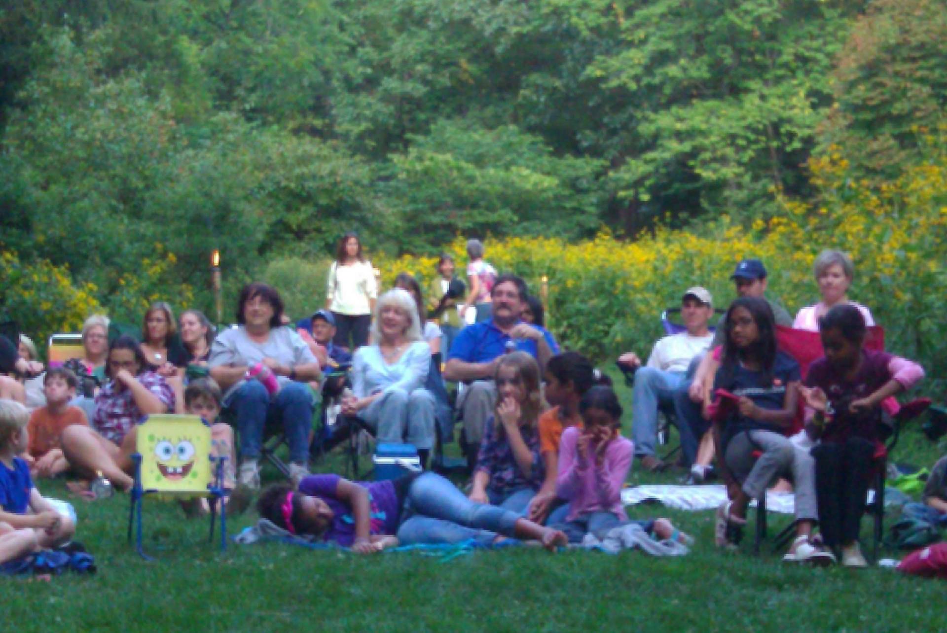 Group of people enjoying a sunny day outdoors in a park.